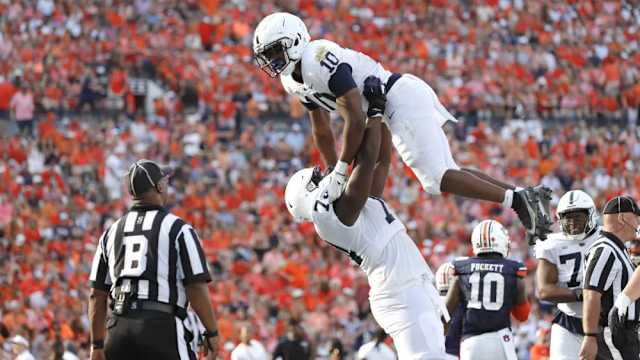 Sep 17, 2022; Auburn, Alabama, USA; Penn State Nittany Lions running back Nicholas Singleton (10) celebrates with offensive lineman Olumuyiwa Fashanu (74) after scoring a touchdown against the Auburn Tigers during the third quarter at Jordan-Hare Stadium.